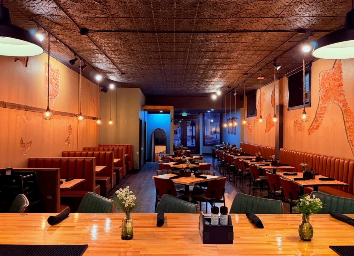 Morning Harvest Cafe dining room with sage green seating and warm rustic decor